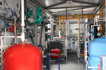 Interior of independent modern gas boiler-house with two steel boilers