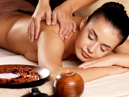 Masseur doing massage on woman body in the spa salon. Beauty treatment concept.