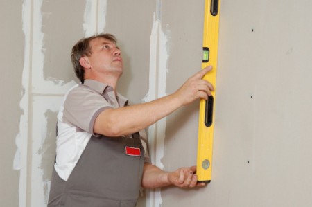 man with level make renovation