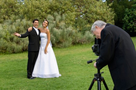 Photographer taking picture of bride and groom
